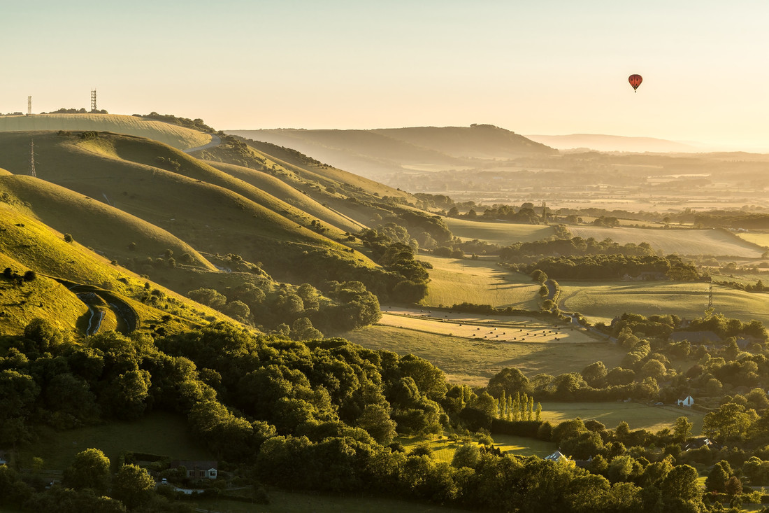 amazing shot of a balloon riding over Devil's Dyke by Robert Maynard