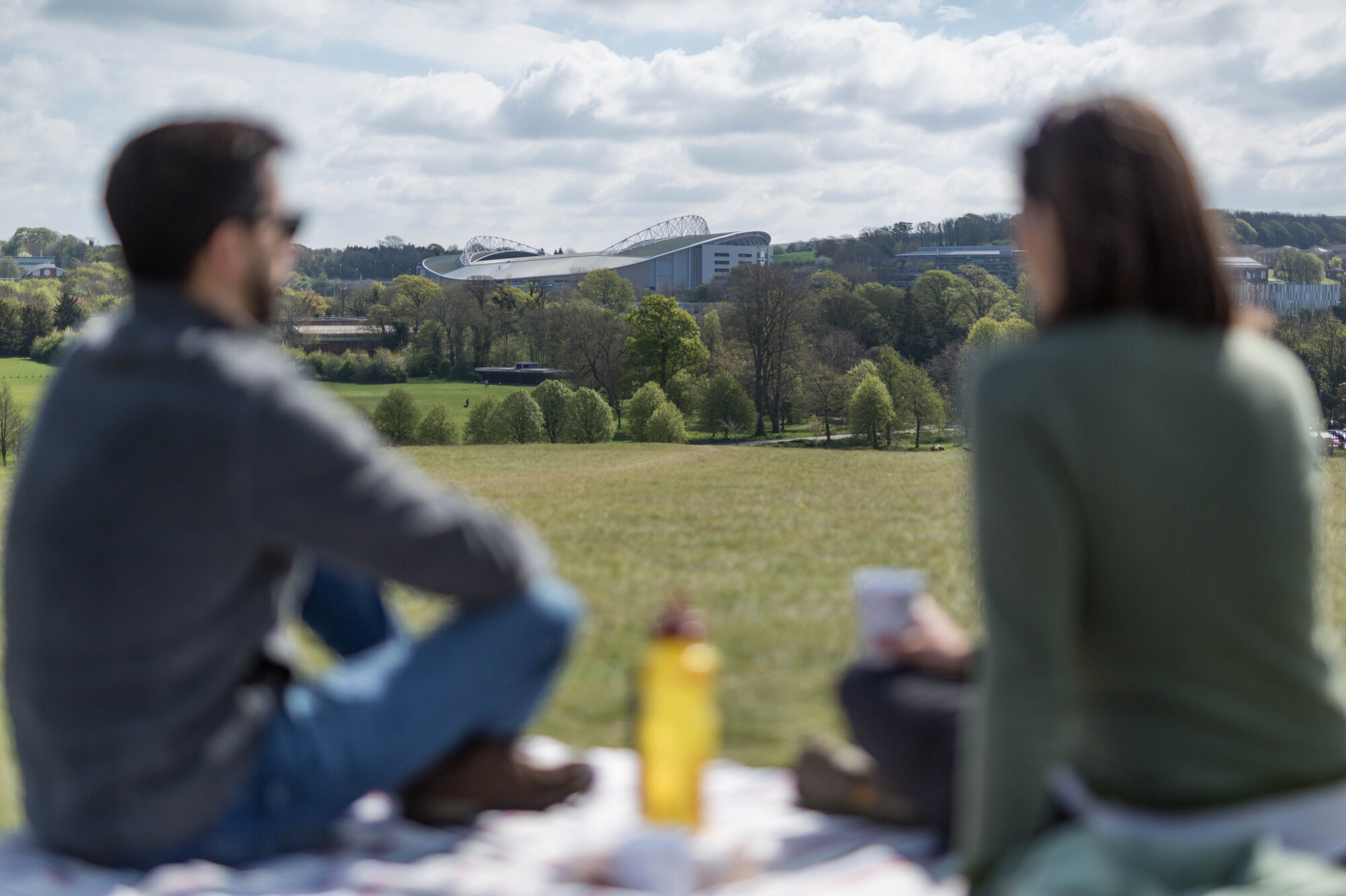 Two people sharing a picnic in a field