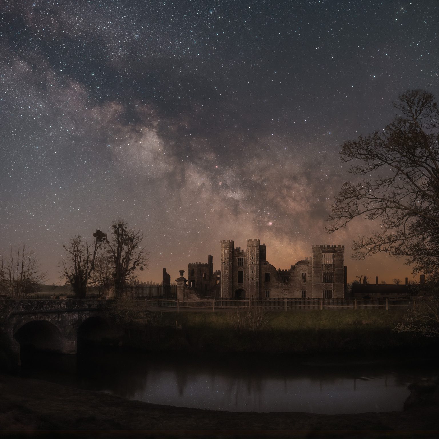 A starry sky over an old ruined castle