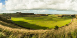 The natural ampitheter of Cheesefoot Head with meadows and a green basin