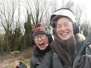 Two female rangers in outdoor uniform smile at the camera