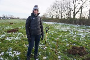 Sonia Lorenzo Martin, who heads woodlands for the National Park Authority, in a field with a spade planting trees