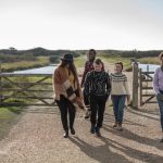 A group of young people walking together in the countryside
